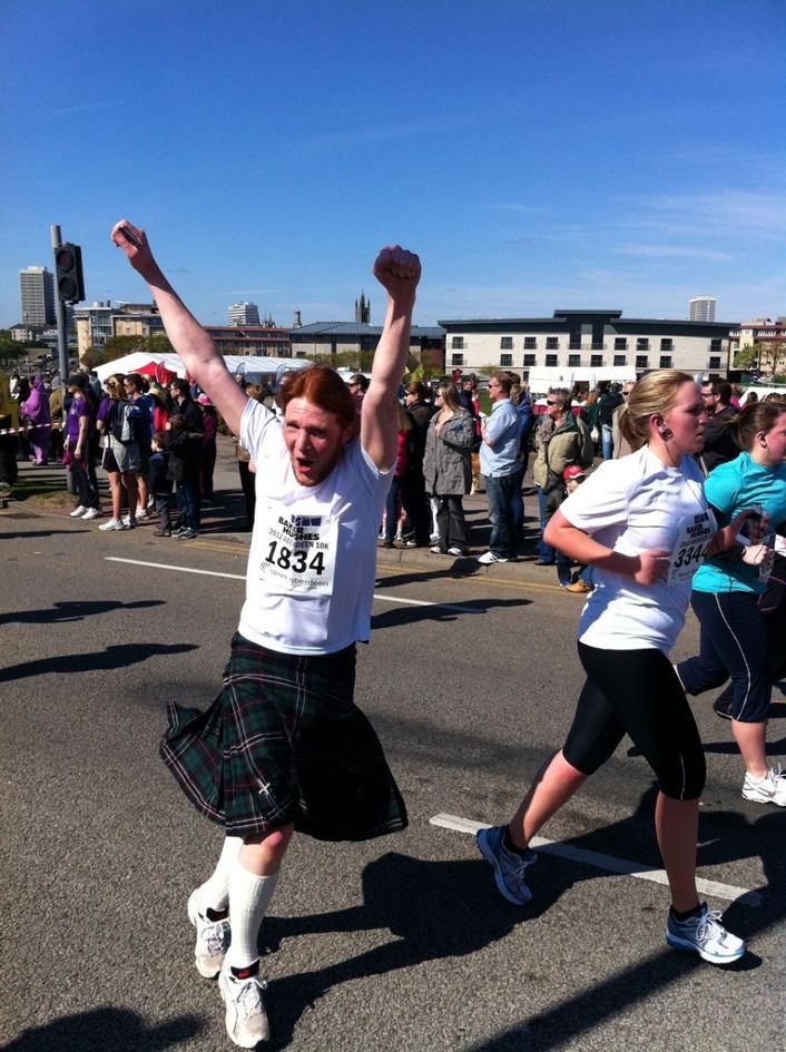 A photo of me running in my Kilt for the Baker Hughes 10K